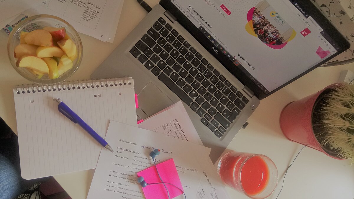 An open laptop with documents
